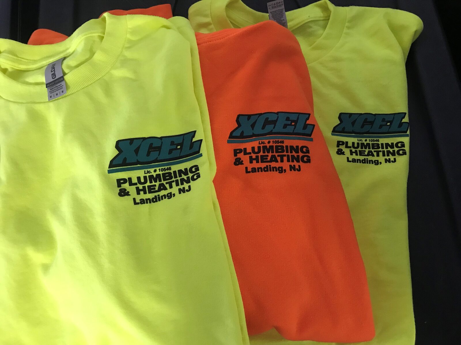 Xcel Plumbing & Heating branded high-visibility crew shirts